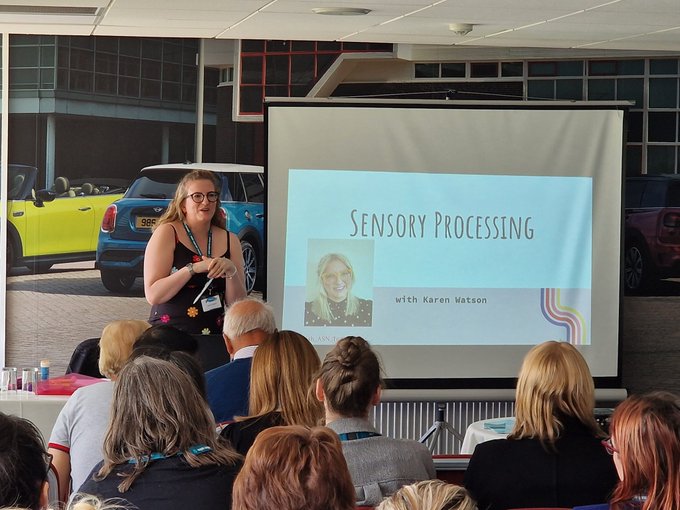 A closer view of Karen presenting to a room of participants.